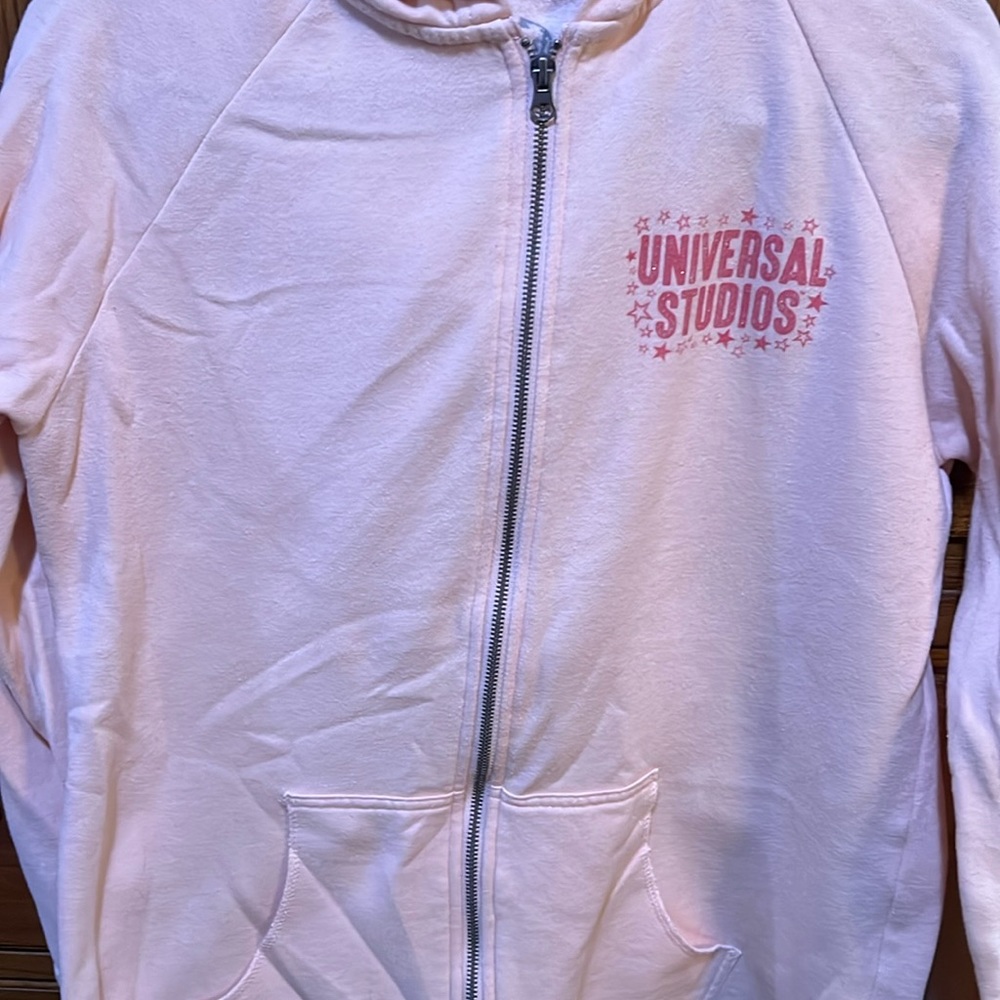 Universal Studios light peach colored hoodie